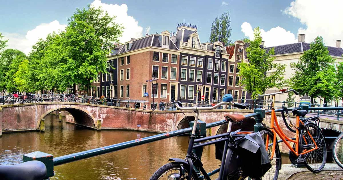 Amsterdam activities on sunny days: Cycle through historic streets, stopping for canal views